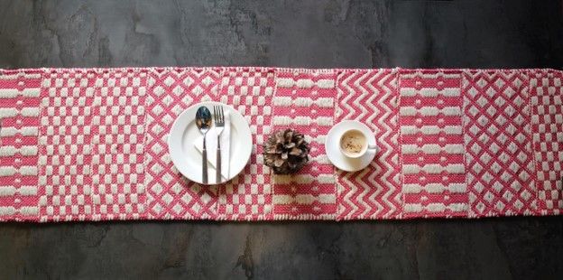 Pink woven table runner laid with a place setting